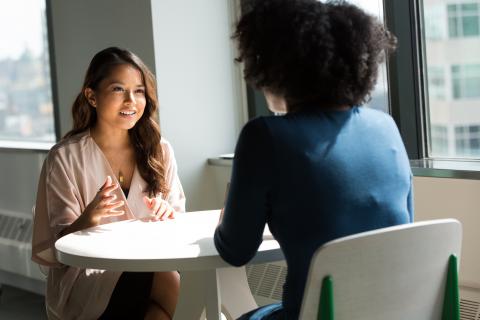 Female boss interviews a female candidate across a round table